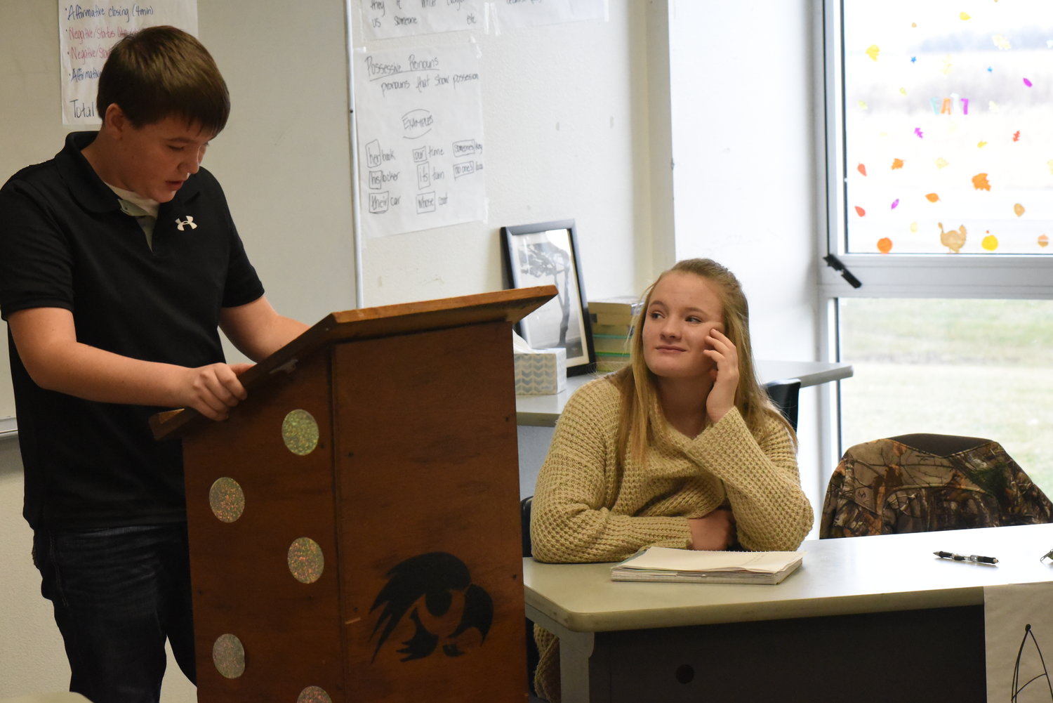 Abby Pierson (right) listens to her teammate Brayden Johnston’s argument on banning cell phones at Highland.