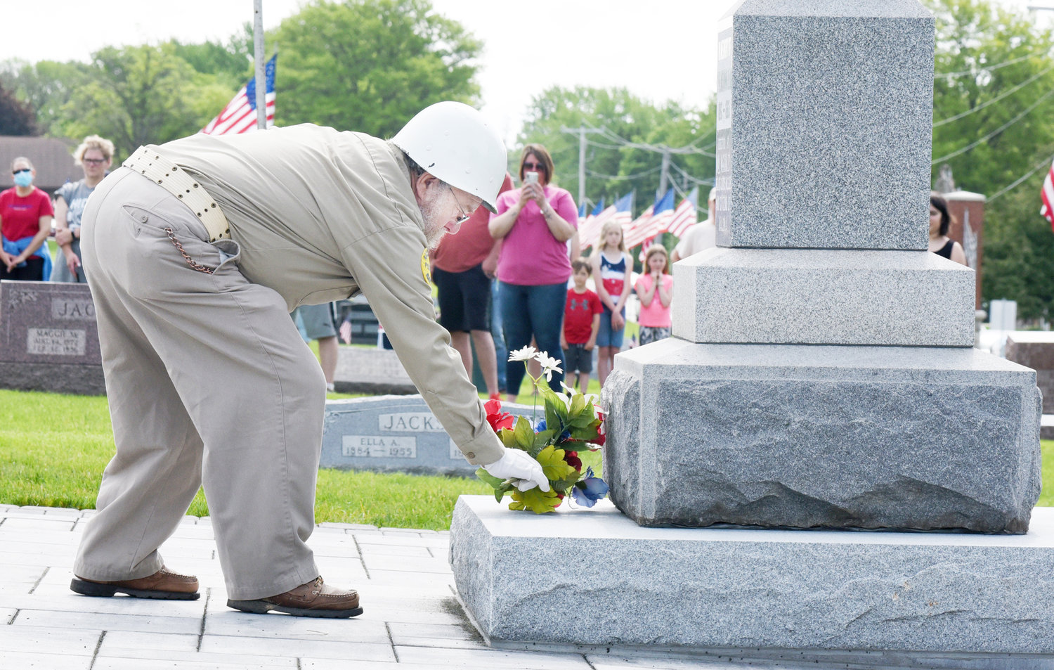 Richmond AmVets Sgt. at Arms Mike Welte lays flowers on the memorial to the unknown dead at Sharon Hill Cemetery.