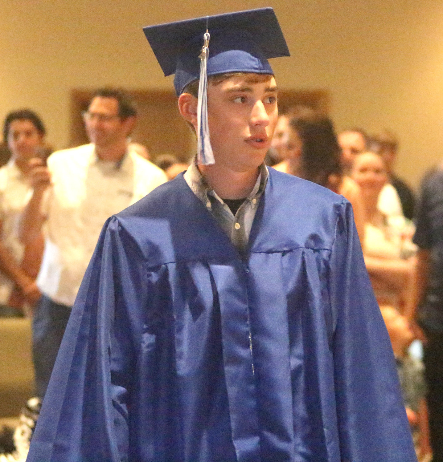 Logan Stutzman marches down the aisle at the start of the ceremony.