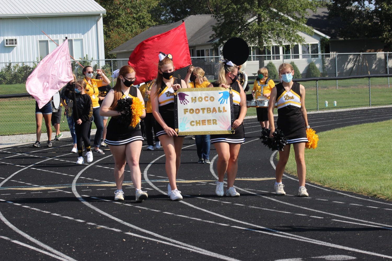 Lone Tree cheerleaders parade around the track during the homecoming assembly.