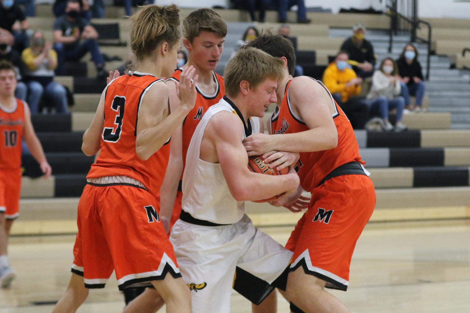 Luke Boyse is surrounded by Bulldog defenders after grabbing a rebound during the first quarter of a scrimmage with Mediapolis in Wellman on Saturday, November 21.