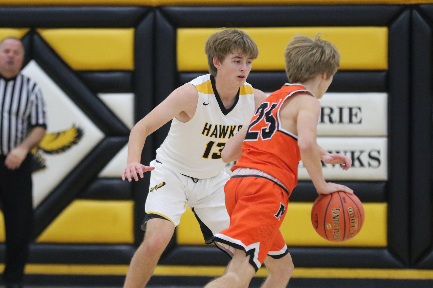 Mid-Prairie's Alex Bean (13) defends a Bulldog ball handler during the first quarter of a scrimmage with Mediapolis in Wellman on Saturday, November 21.