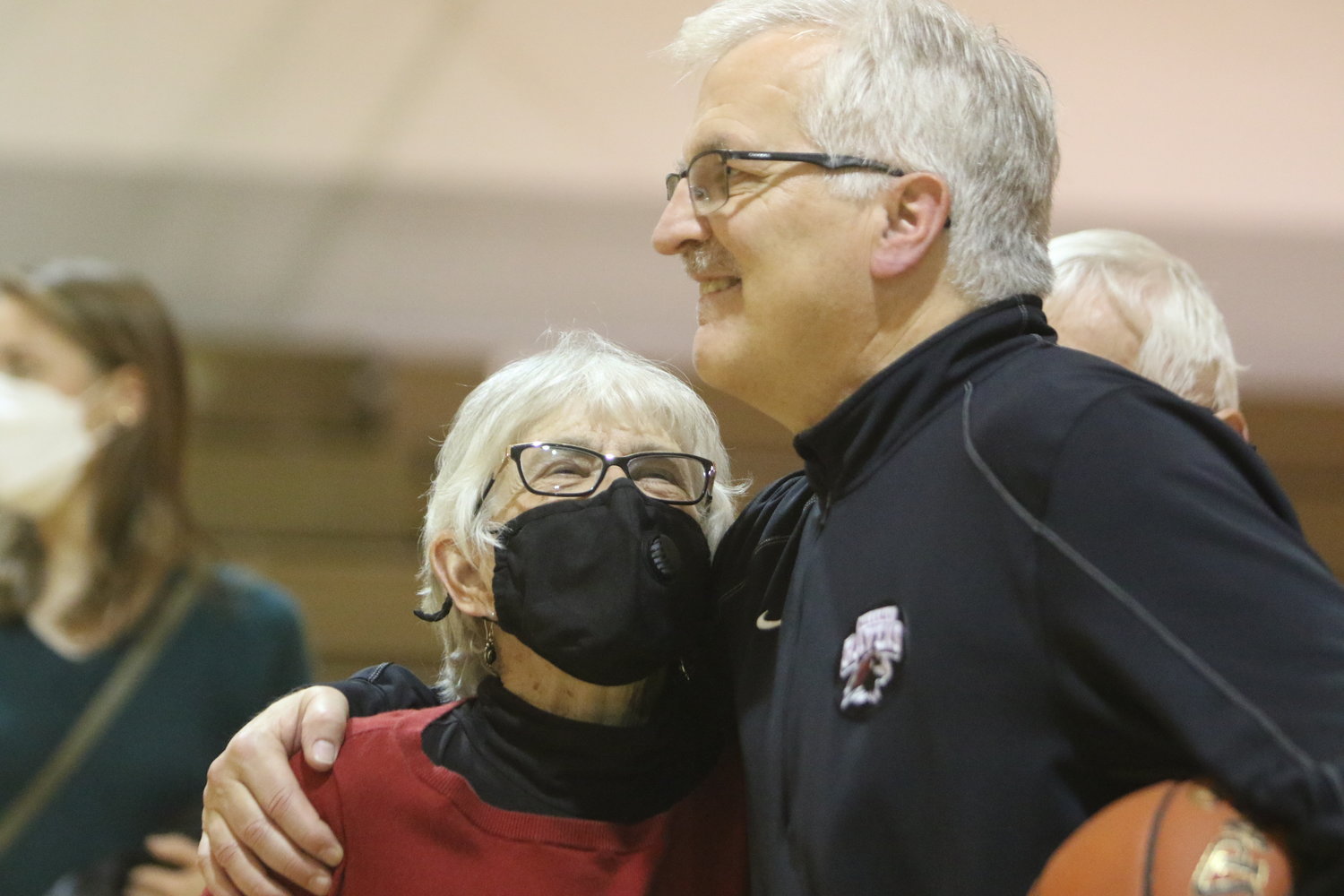 Longtime Hillcrest Academy boys basketball coach and school principal Dwight Gingerich enjoys the Alumni Night celebration following a victory over Highland on December 21. It was his 702nd win.