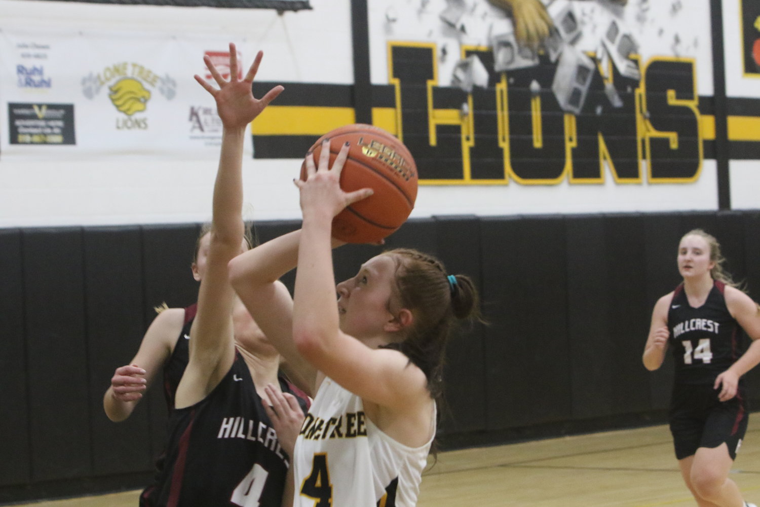 Riley Krueger of Lone Tree goes up for a shot against Hillcrest's Norah Yoder.