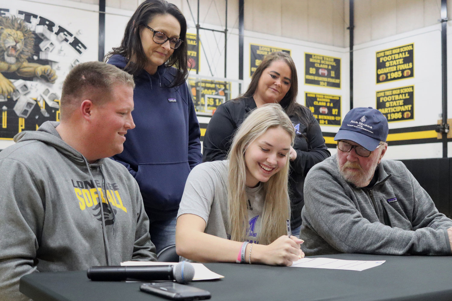 Lone Tree senior Ellen Carow signs with the McCook Community College softball program on Wednesday, January 5. Front, from left, Lone Tree coach Reid Kaalberg, Ellen Carow, and her father Mike Carow. Back, Carow's mother Jessica Runge and McCook assistant softball coach Maddie Kaalberg.