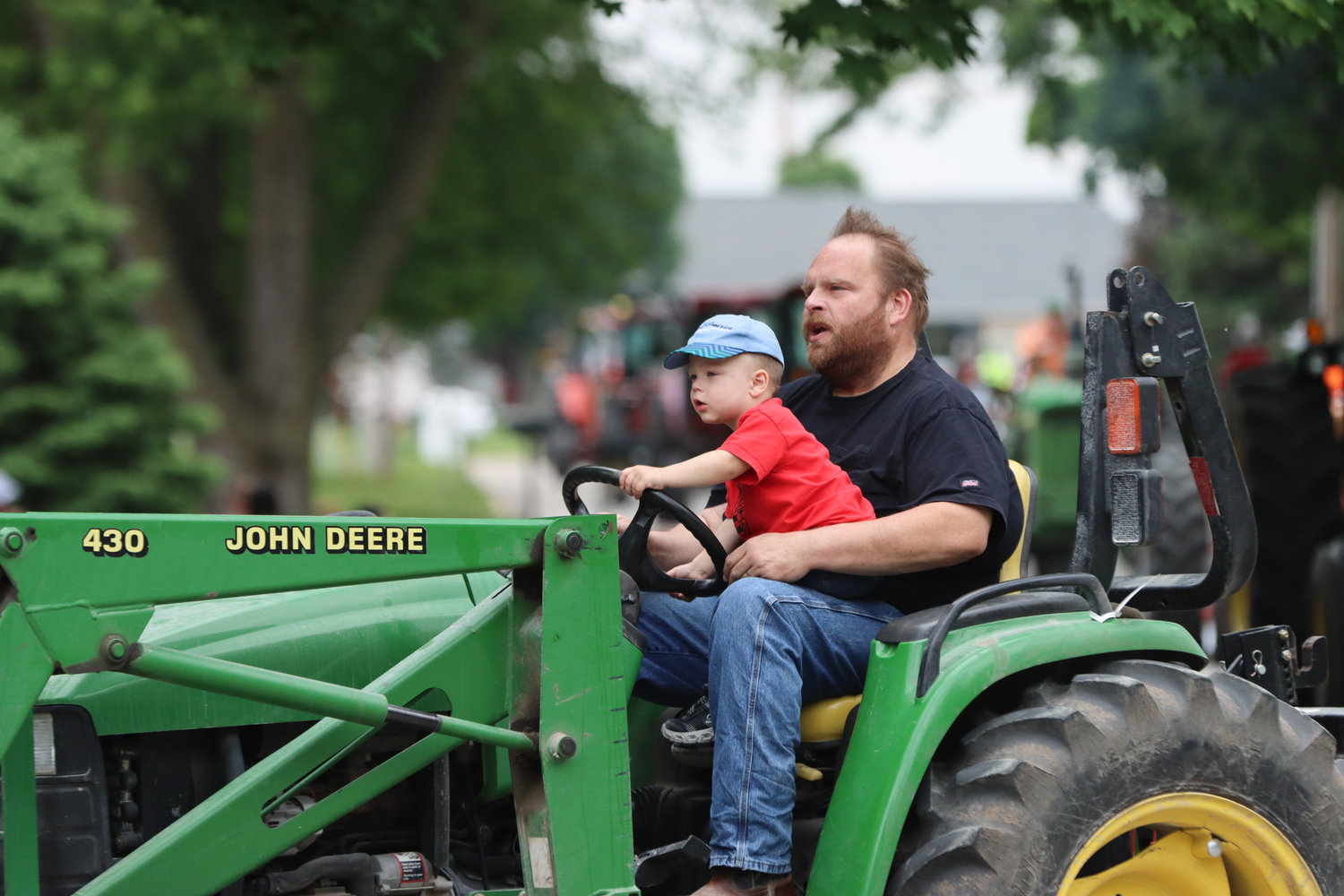 A young driver steers through the Kalona Tractorcade on Saturday, June 4.