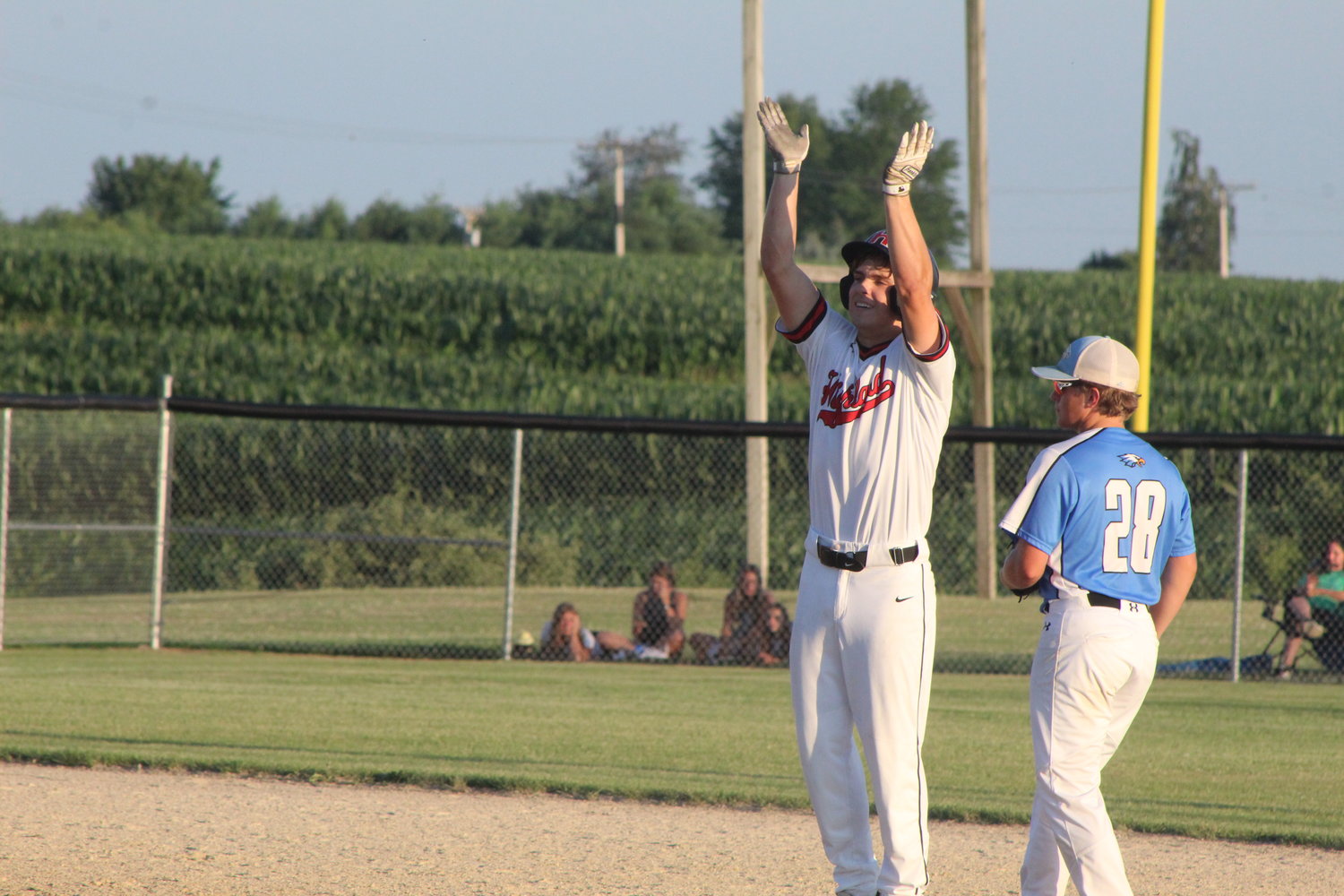 Highland senior Connor Grinstead celebrates after hitting a run-scoring double against Lynnville-Sully in the district final.