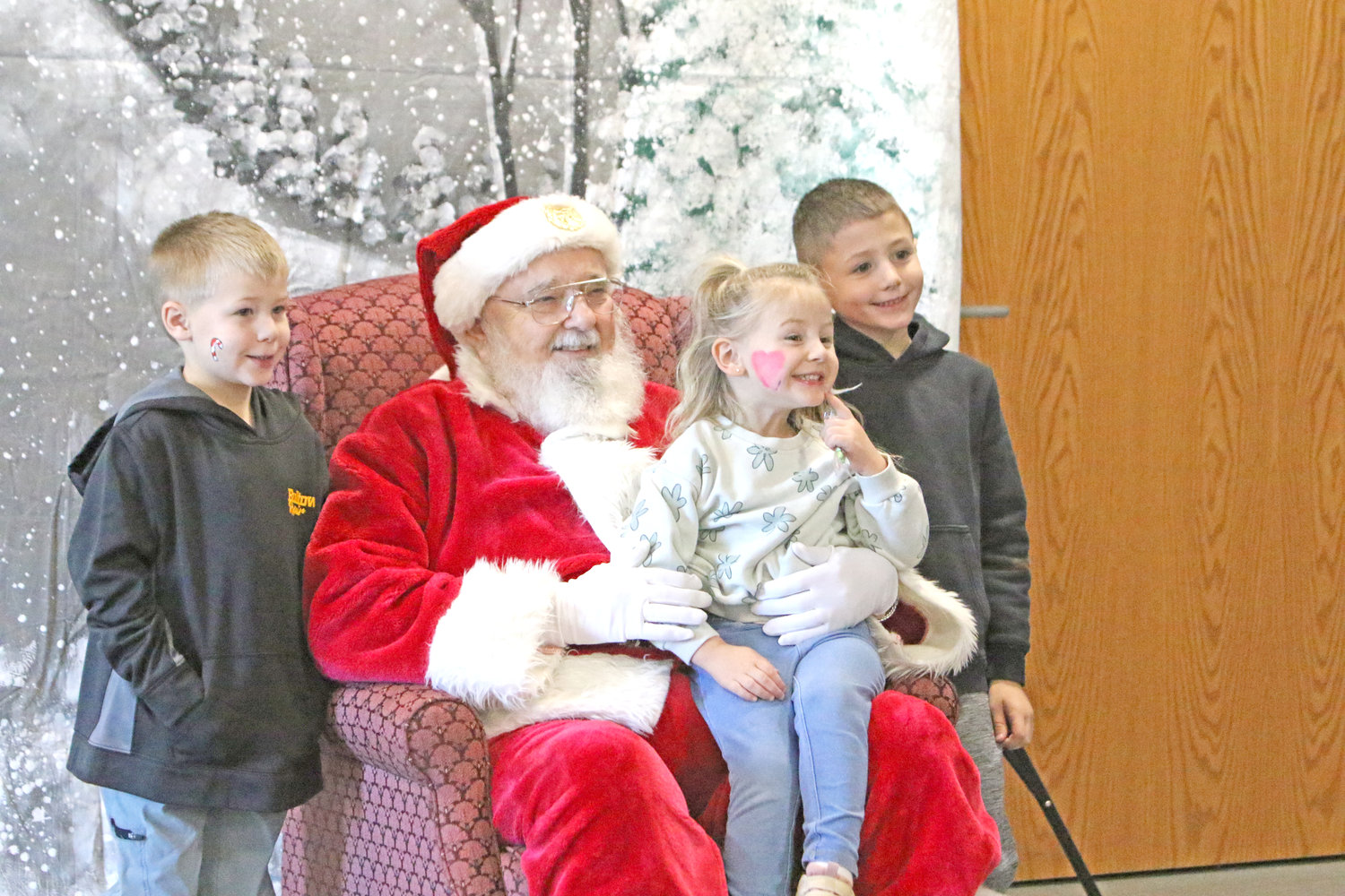 Kids flocked to Santa at the YMCA, whose visit was sponsored by The News/Slechta Communications.
