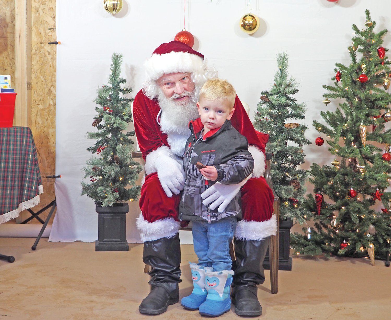 A cookie in hand and attention from Santa – a perfect Saturday afternoon.