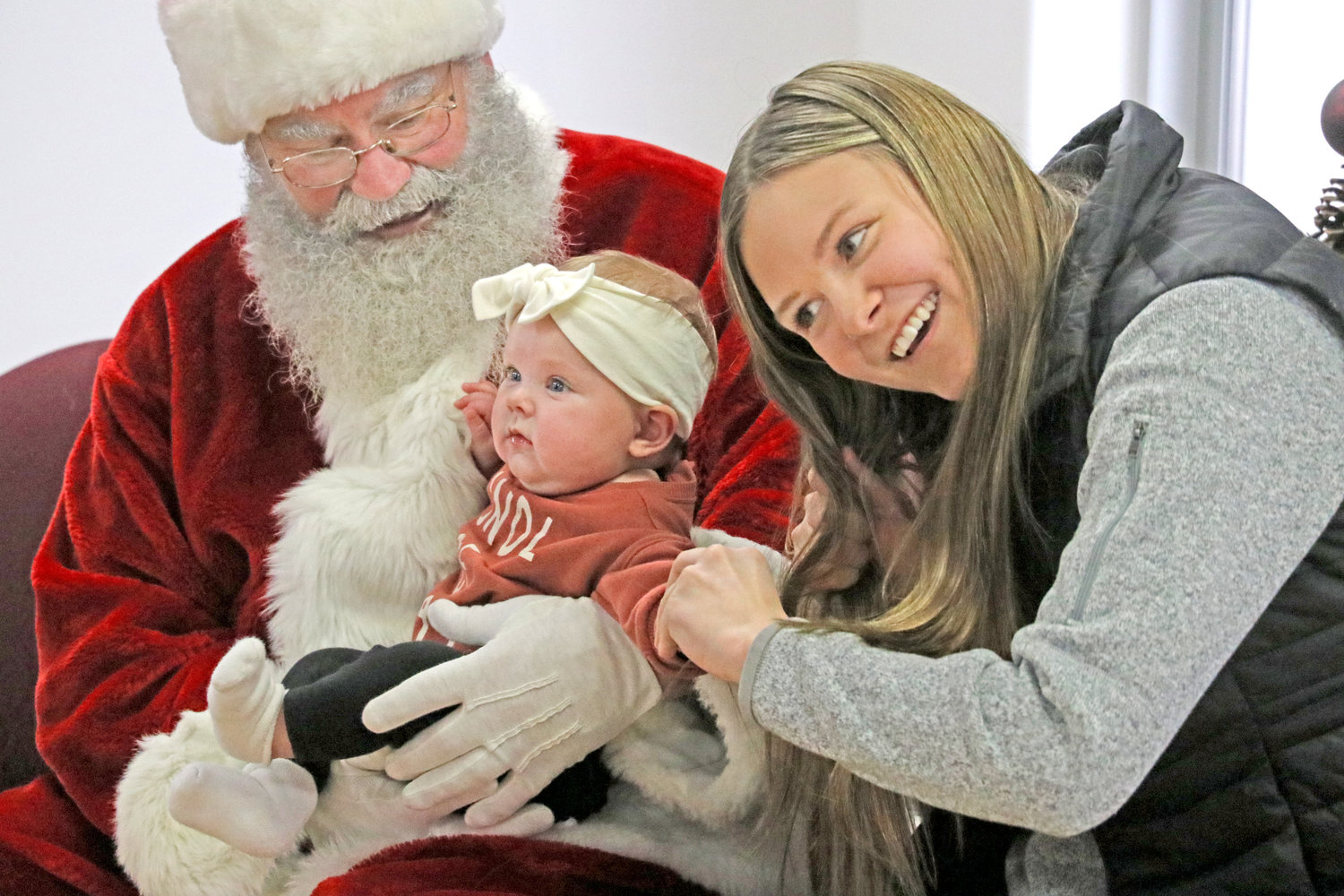 A hug from Santa makes for a memorable first Christmas.