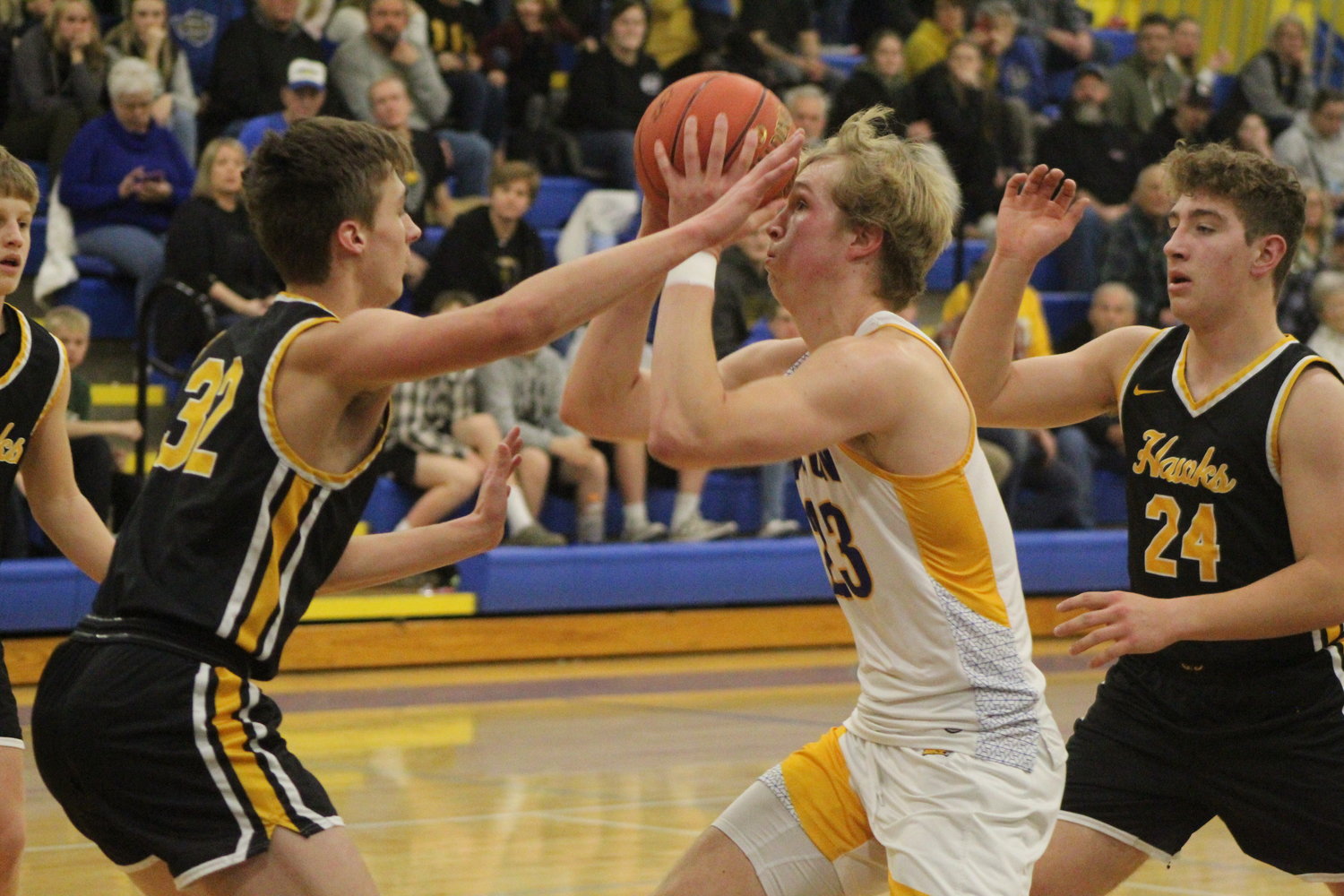Wilton's Caden Kirkman drives into the lane against Mid-Prairie's Dylan Henry.