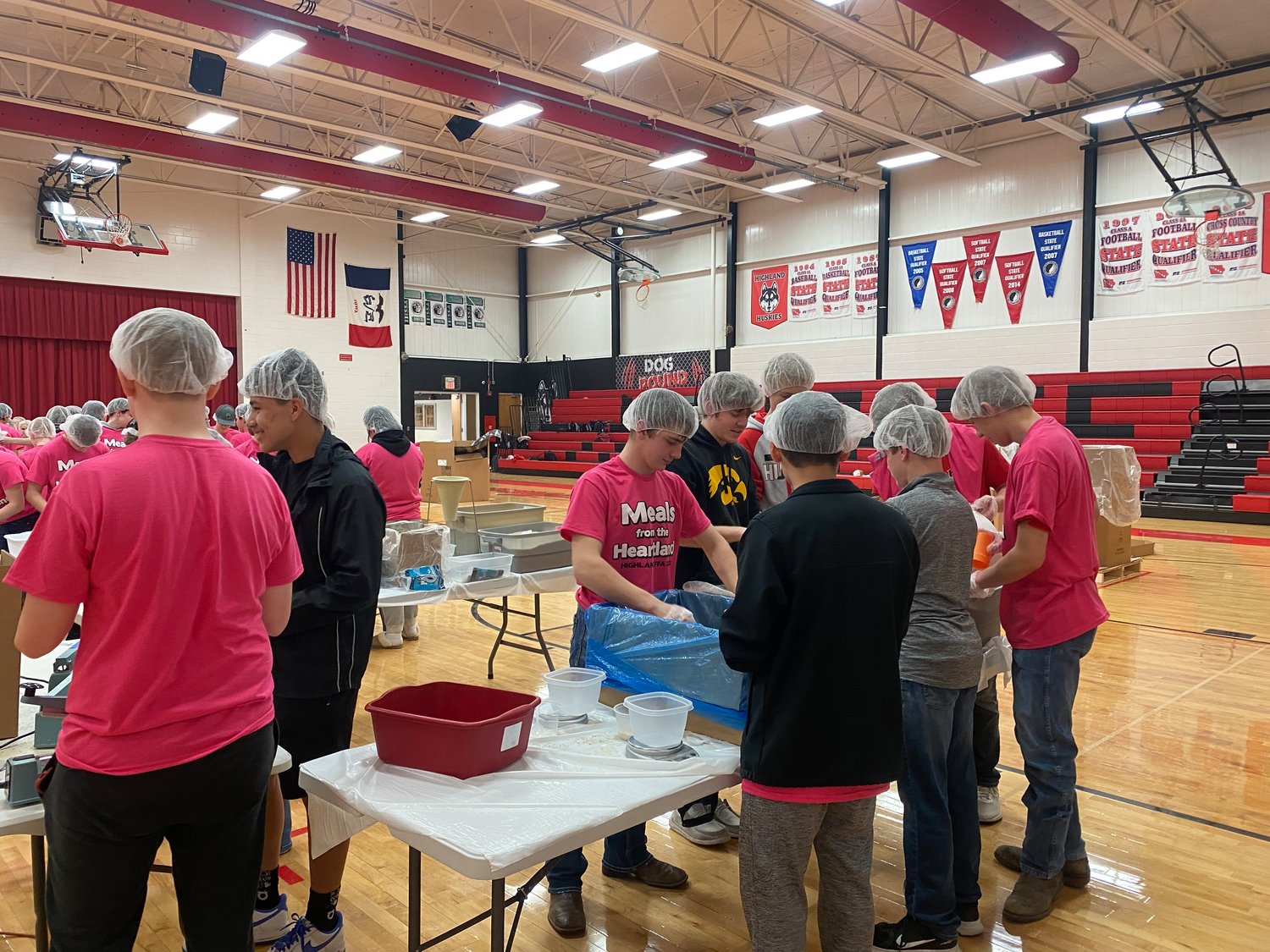 Two more tables than last year, for a total of 10, were needed to package 40,000 meals in the Highland gym.