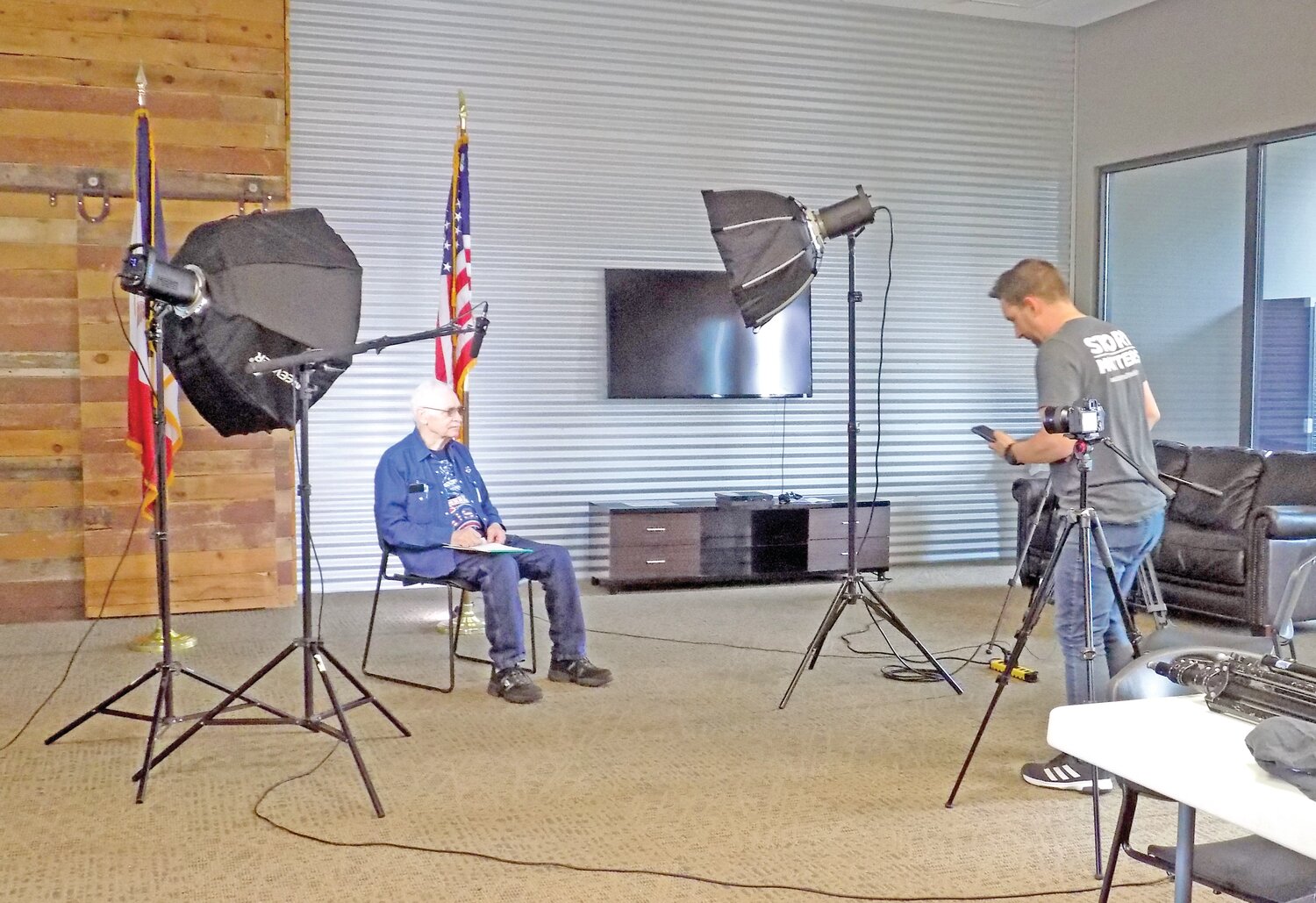 U.S. Air Force veteran Paul Christen, left, gets ready to answer John Choate’s questions before the cameras on May 19.