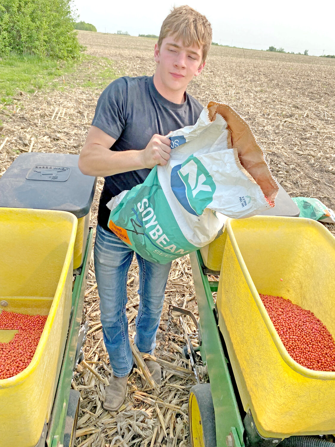 Brock Thomann (freshman) filling the planter with seed.