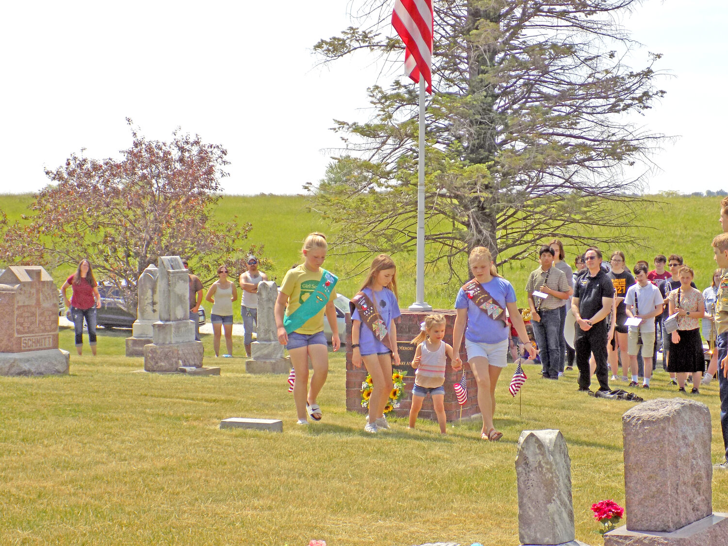 The Girl Scouts place a wreath in remembrance of servicemembers at Richmond Catholic Cemetery.