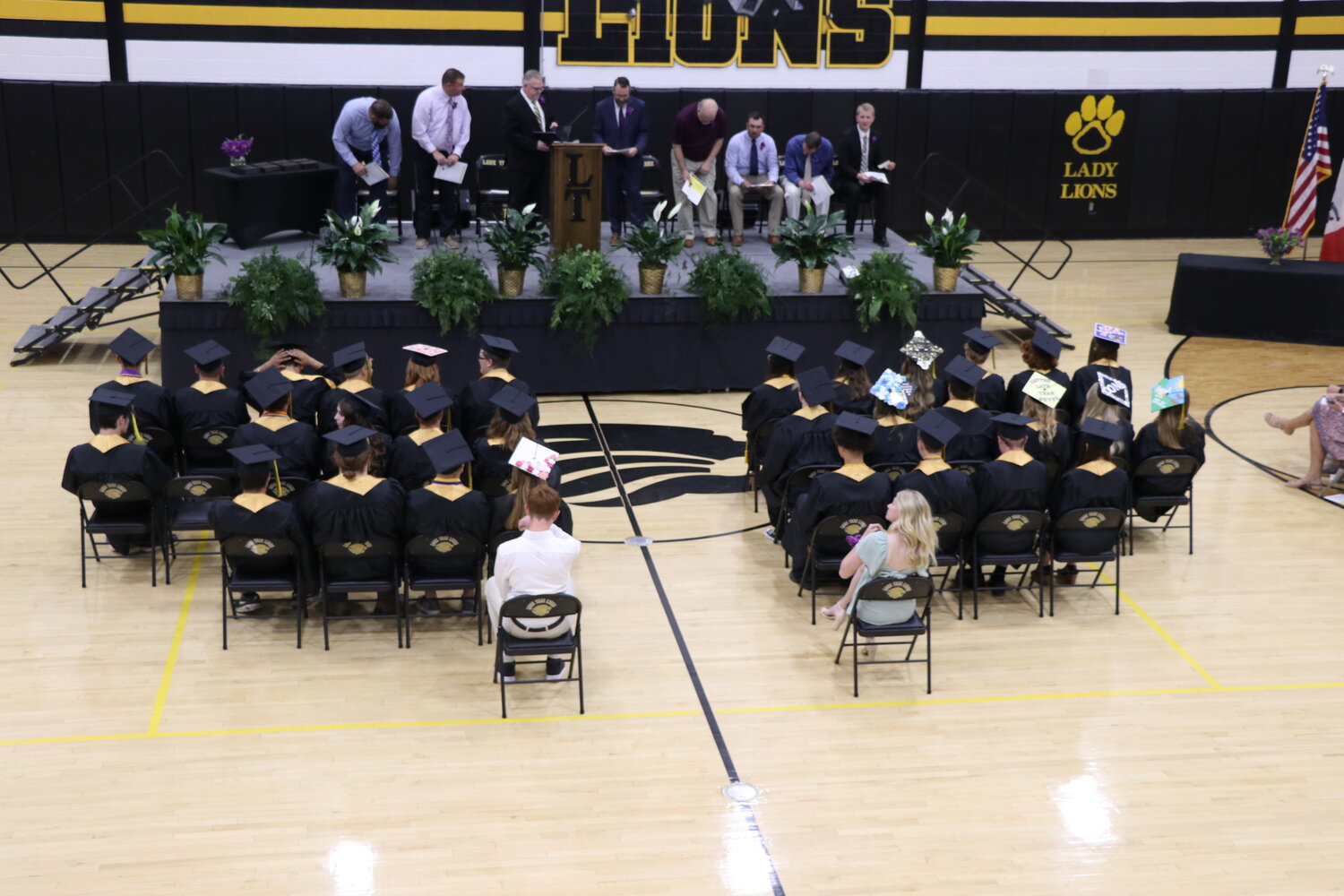 The Lone Tree class of 2023 settles into their seats after entering the gymnasium for their graduation ceremony.