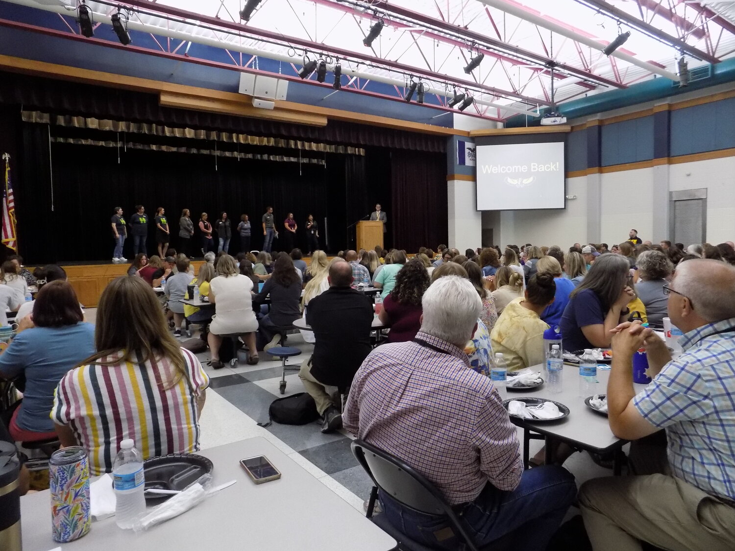 Mid-Prairie’s full district staff enjoyed lunch provided by Hills Bank (the staff of which are on stage) at their meeting on August 21.