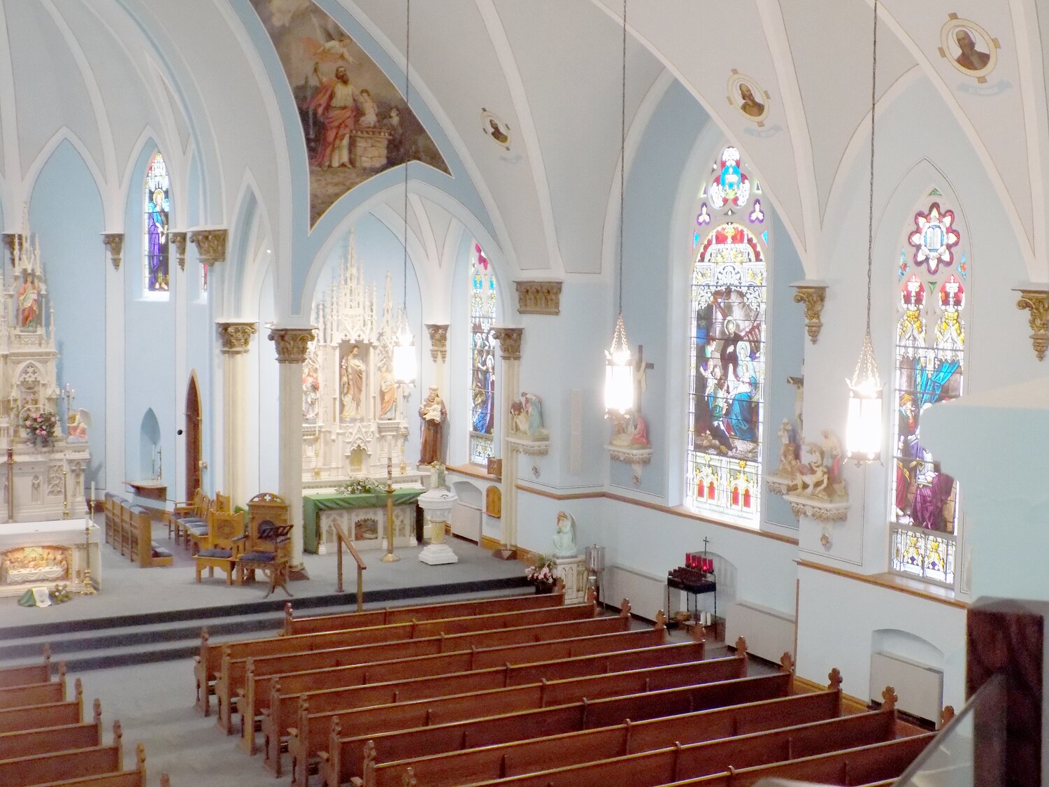 Sacred art surrounds parishioners at St. Mary’s, from ceiling frescos and paintings to statuary, stained-glass windows, and the Stations of the Cross.