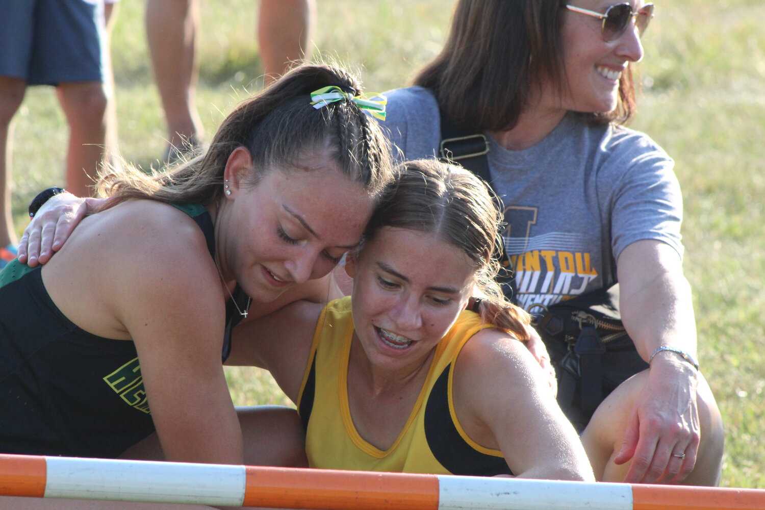 Mid-Prairie's Danielle Hostetler, right, and Dubuque Hempstead's Keelee Leitzel share a moment after finishing one-two in the Trojan Early Bird.