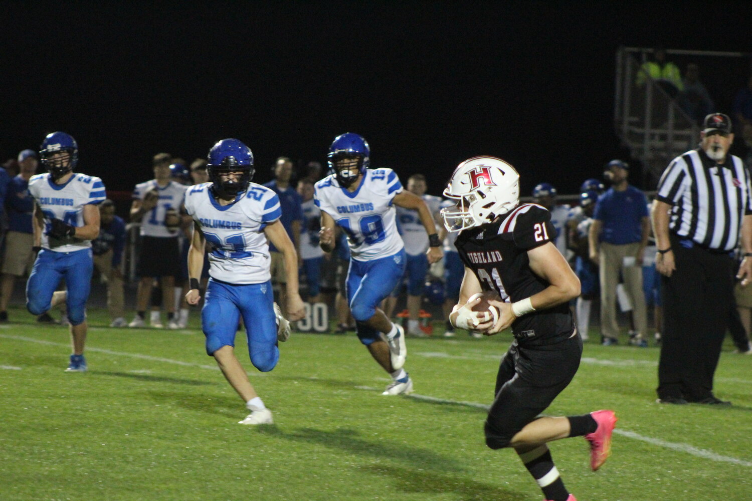 Highland's Jack Peiffer heads downfield after catching his first varsity pass against Columbus.