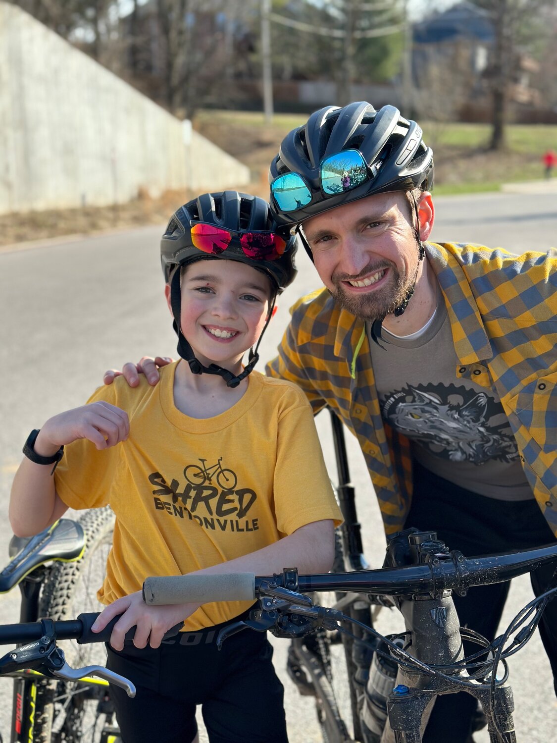 Attracting kids to cycling is one of race director Caleb Wilson’s (right) passions.  Son Paxton is ready to roll.