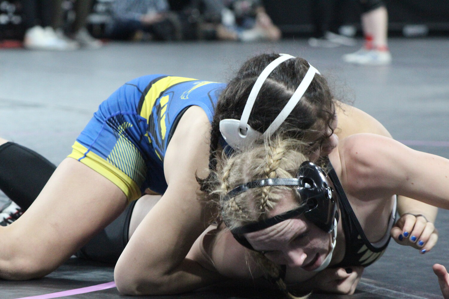 Ellie Brenneman of Mid-Prairie battles against fourth-ranked Bella Miller of Dubuque Wahlert at the state championships.